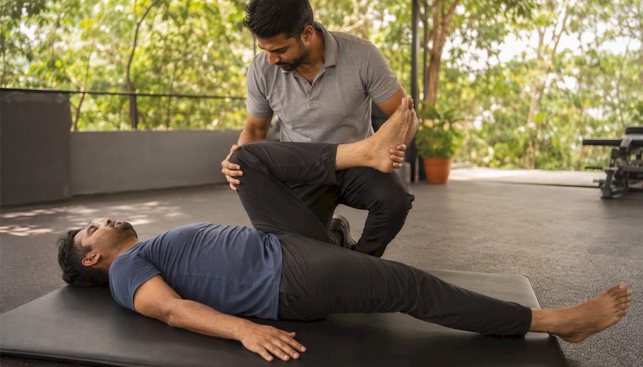 Physiotherapist assisting hip flexor stretch