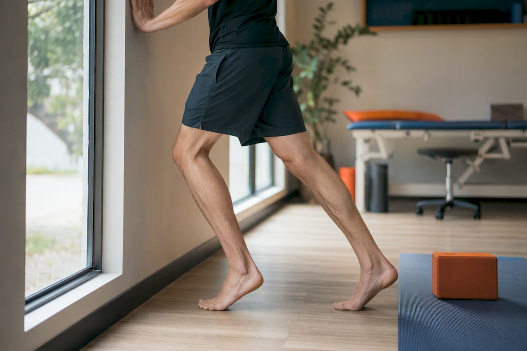 Person doing soleus stretch with bent knee