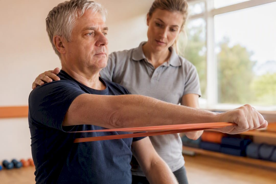 Patient performing rotator cuff resistance band exercise