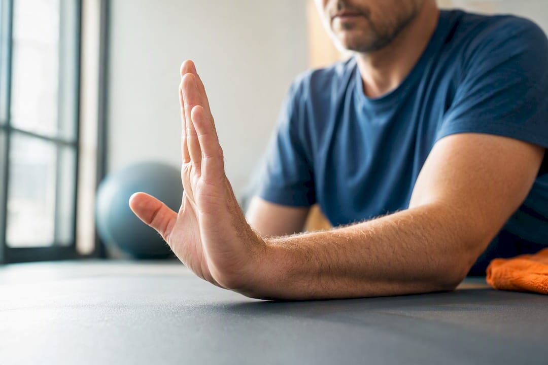 Patient performing gentle wrist mobility exercise