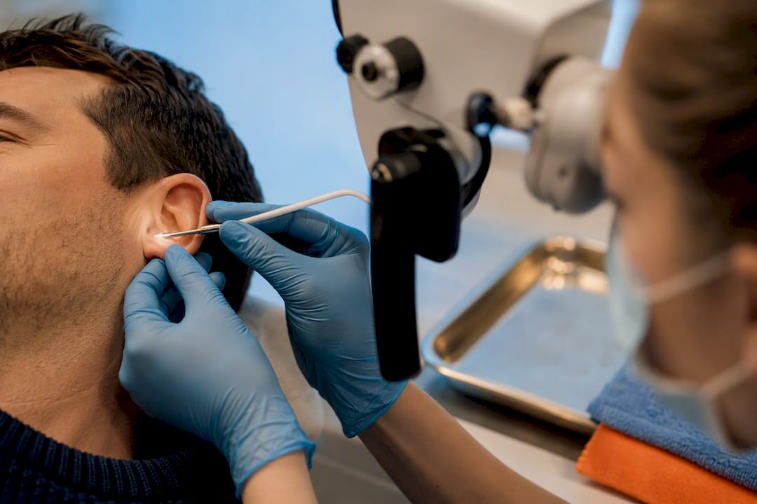Clinician performing microsuction ear removal