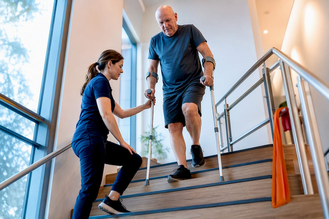 Patient practising stairs after hip replacement