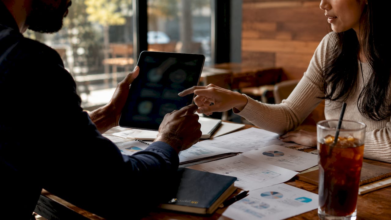 Close-up of hands using tablet in meeting