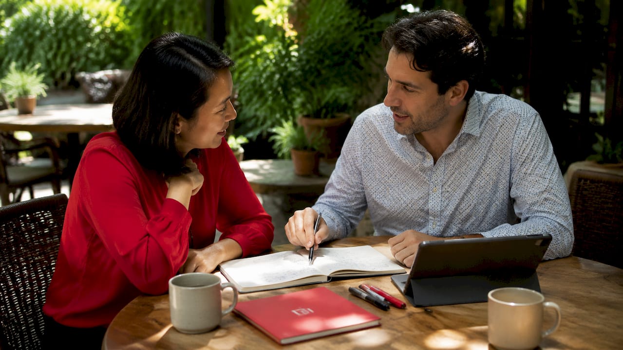 Two researchers discussing notes in meeting room