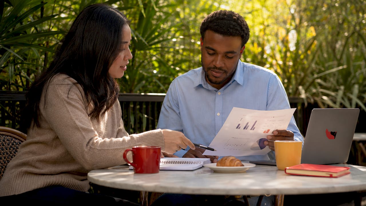 Colleagues comparing research and evaluation documents