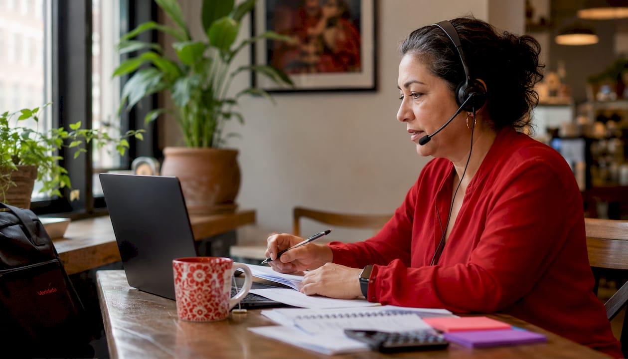 Woman administering questionnaire via phone headset