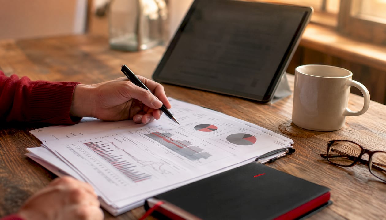 Overhead view of desk with market research materials