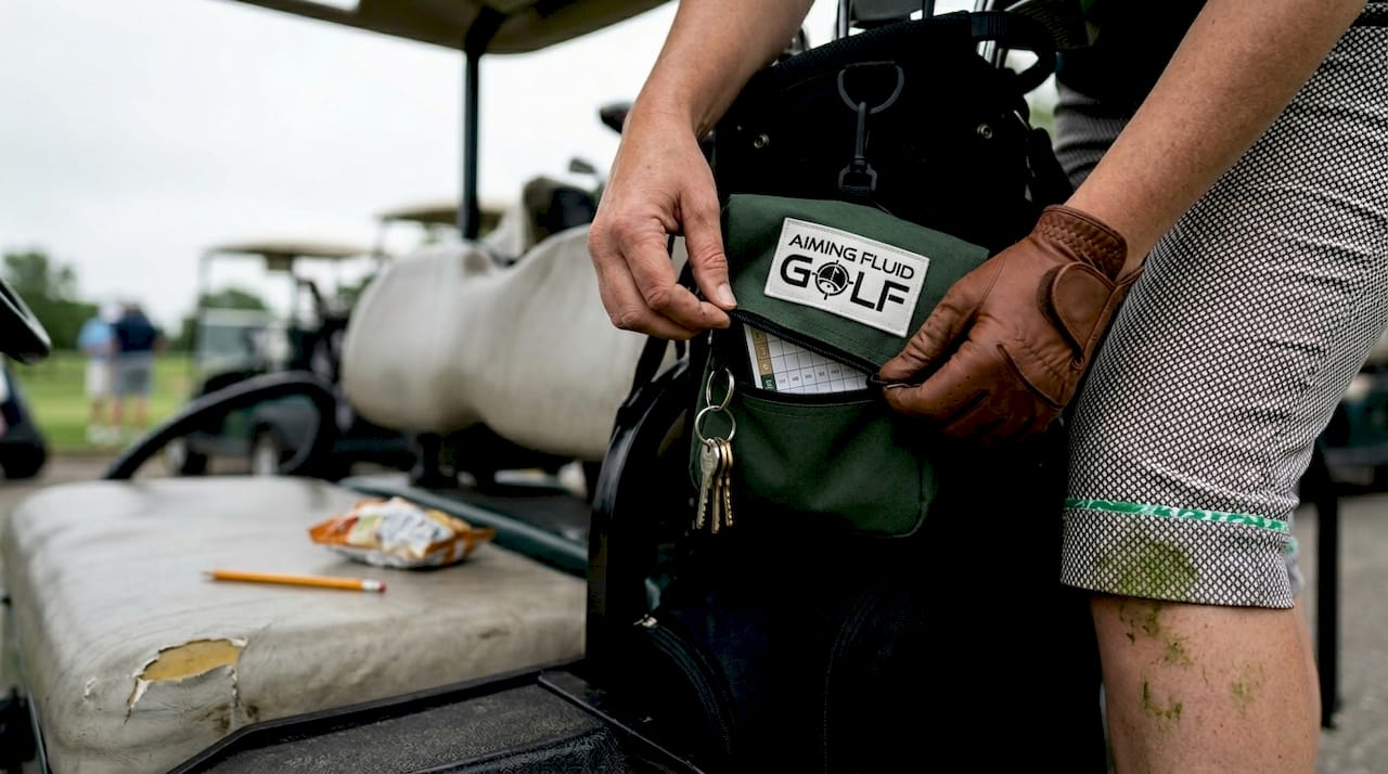 Golfer closing pouch for valuables in bag