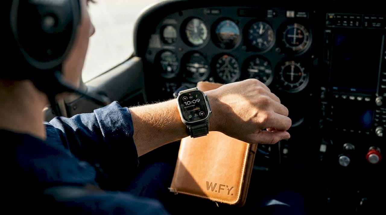 Female pilot checking Apple Watch in cockpit