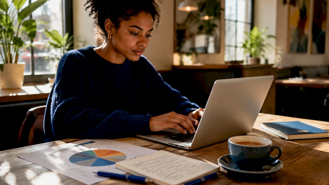 Hands typing dynamic pricing algorithm on laptop