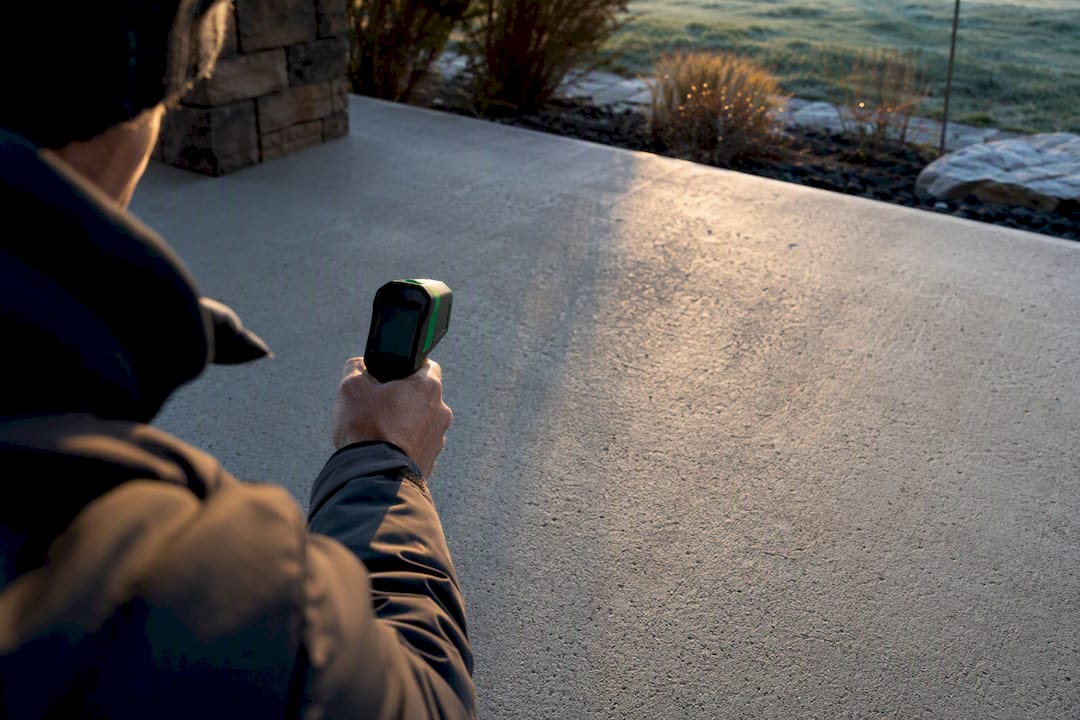 Infrared thermometer measuring concrete surface