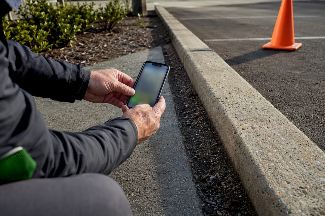 Property manager photographing curb-line debris