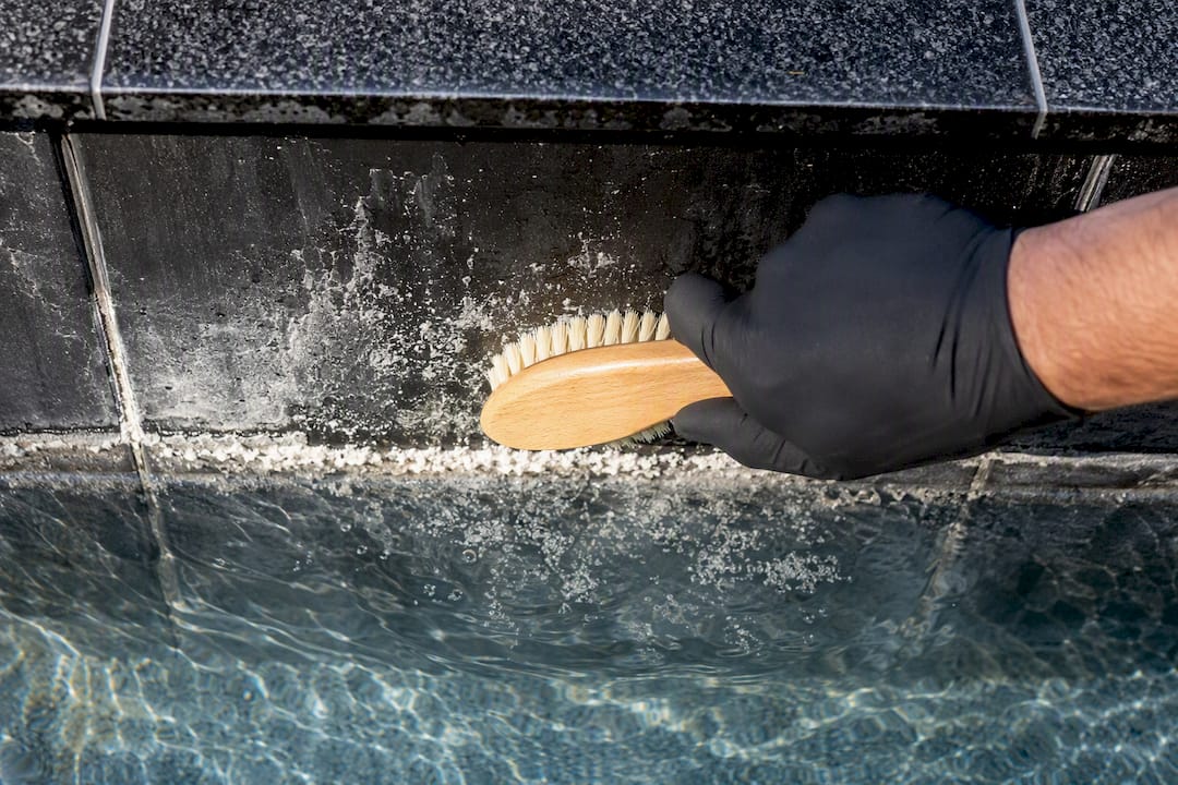 Soft brush removing calcium from spillway tile