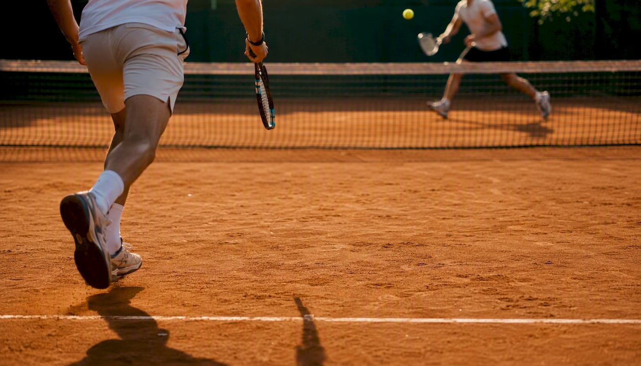 Players moving on clay court during long match rally
