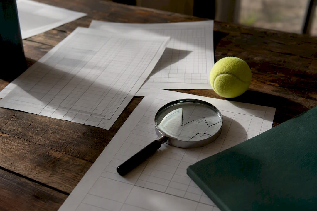Tennis stats charts and scorecards on table