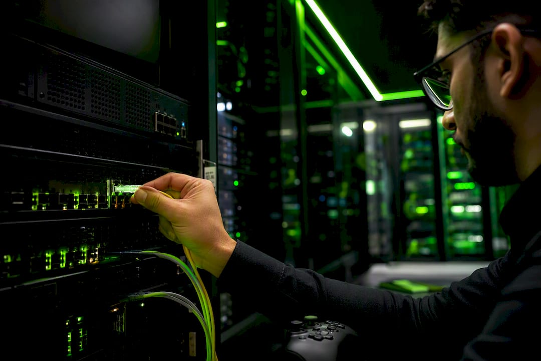 Hand plugging cable into server rack