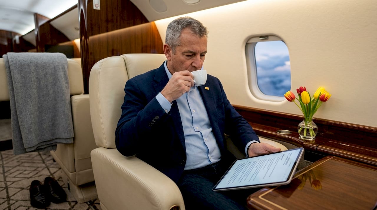 Traveler reading notes in private jet cabin