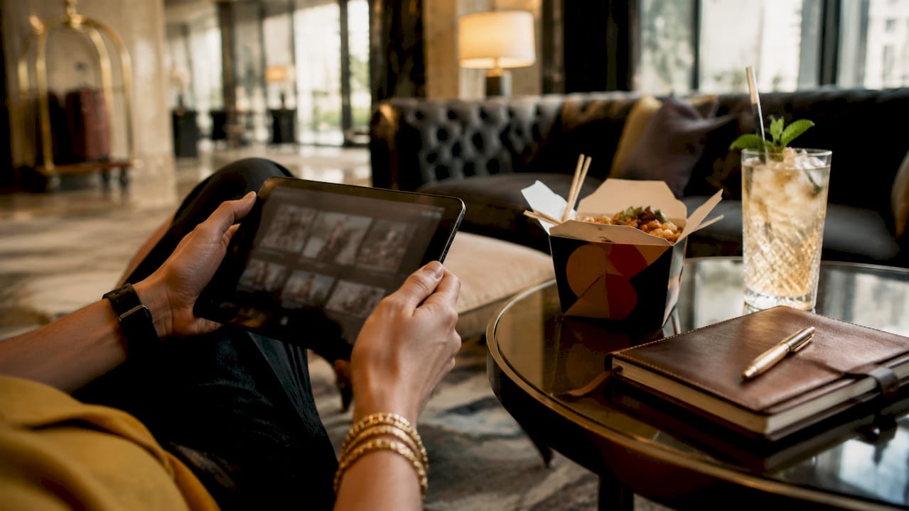Hands using tablet for restaurant recommendations in kitchen