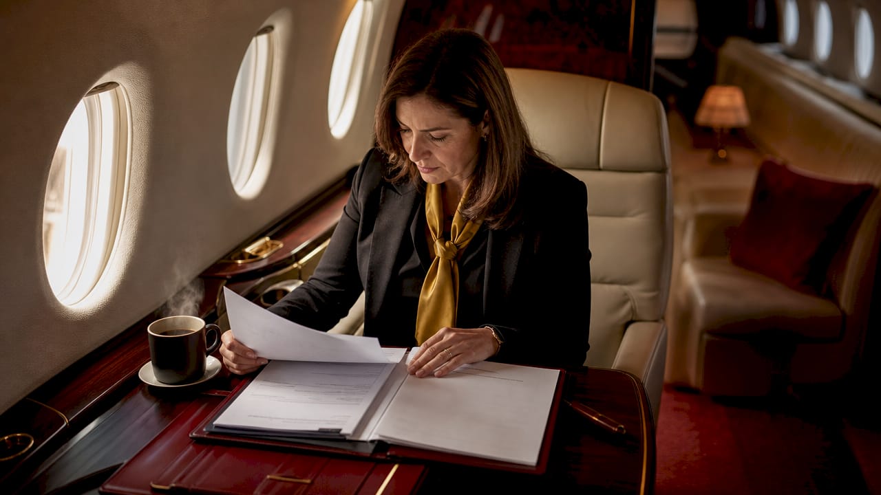 Businesswoman reviewing documents in private jet cabin