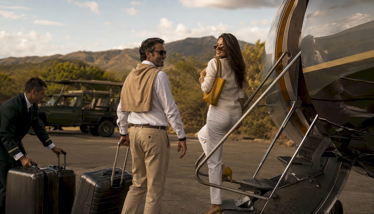 Luxury clients boarding private jet for safari