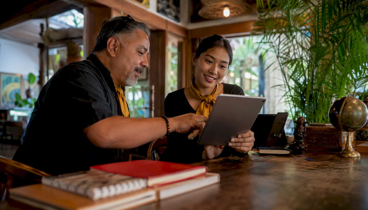 Vacation ambassadors consulting travel options at concierge desk