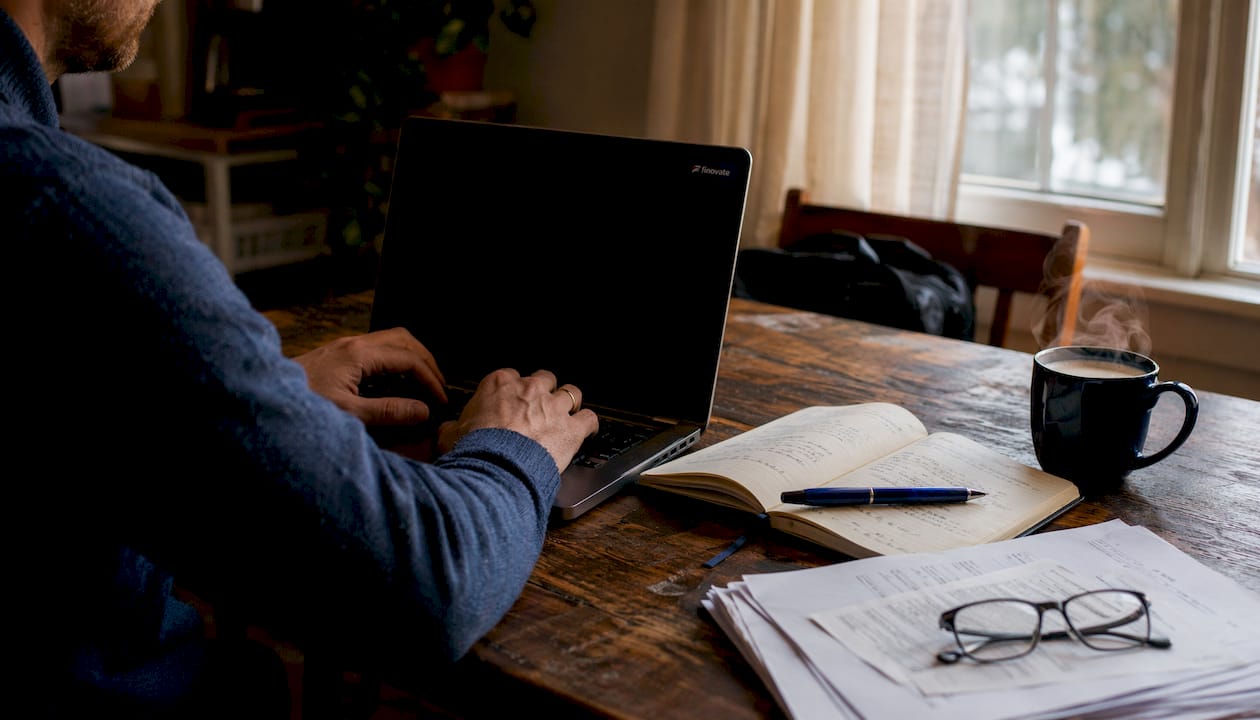 Hands typing on laptop at home office desk