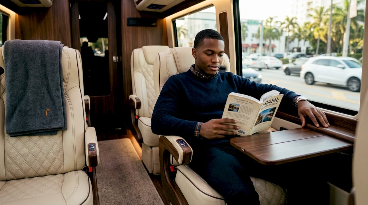 Passenger enjoying premium shuttle leather seating comfort