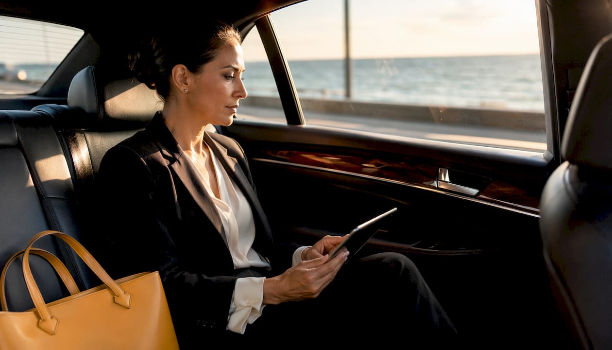 Miami VIP Car Service - 1784065062833 Businesswoman working quietly in premium car cabin Businesswoman working quietly in premium car cabin