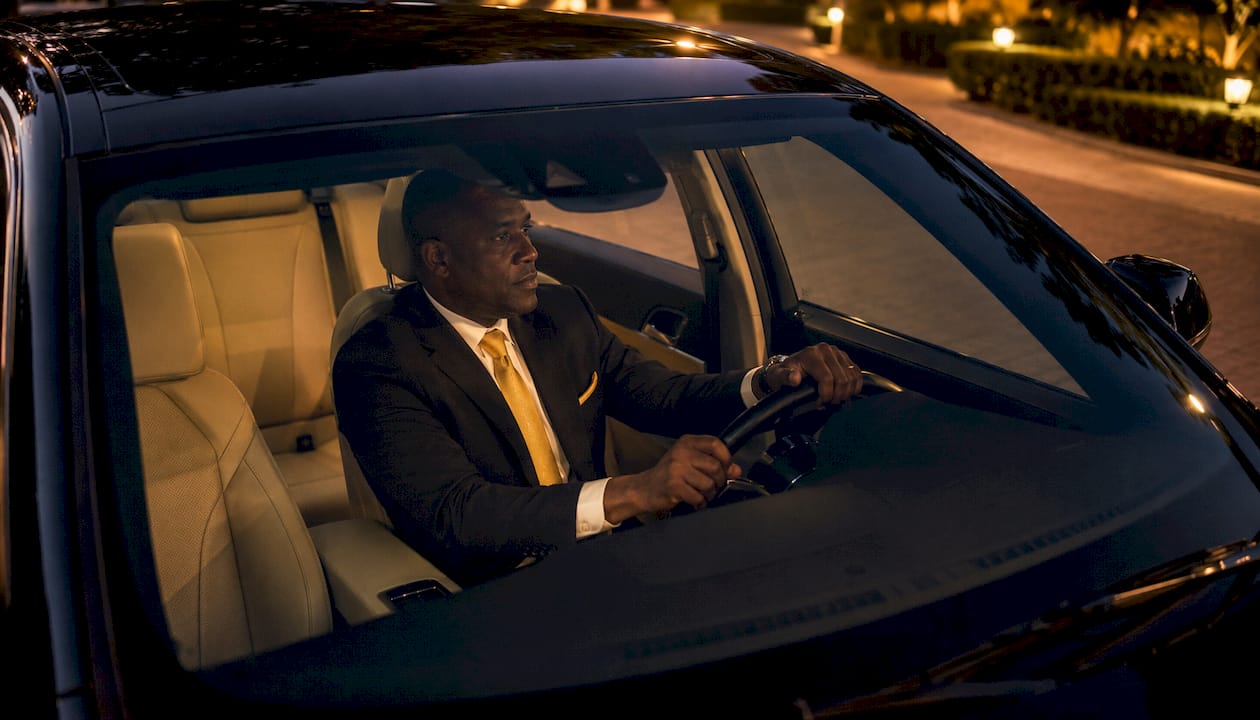 Chauffeur waiting inside luxury SUV