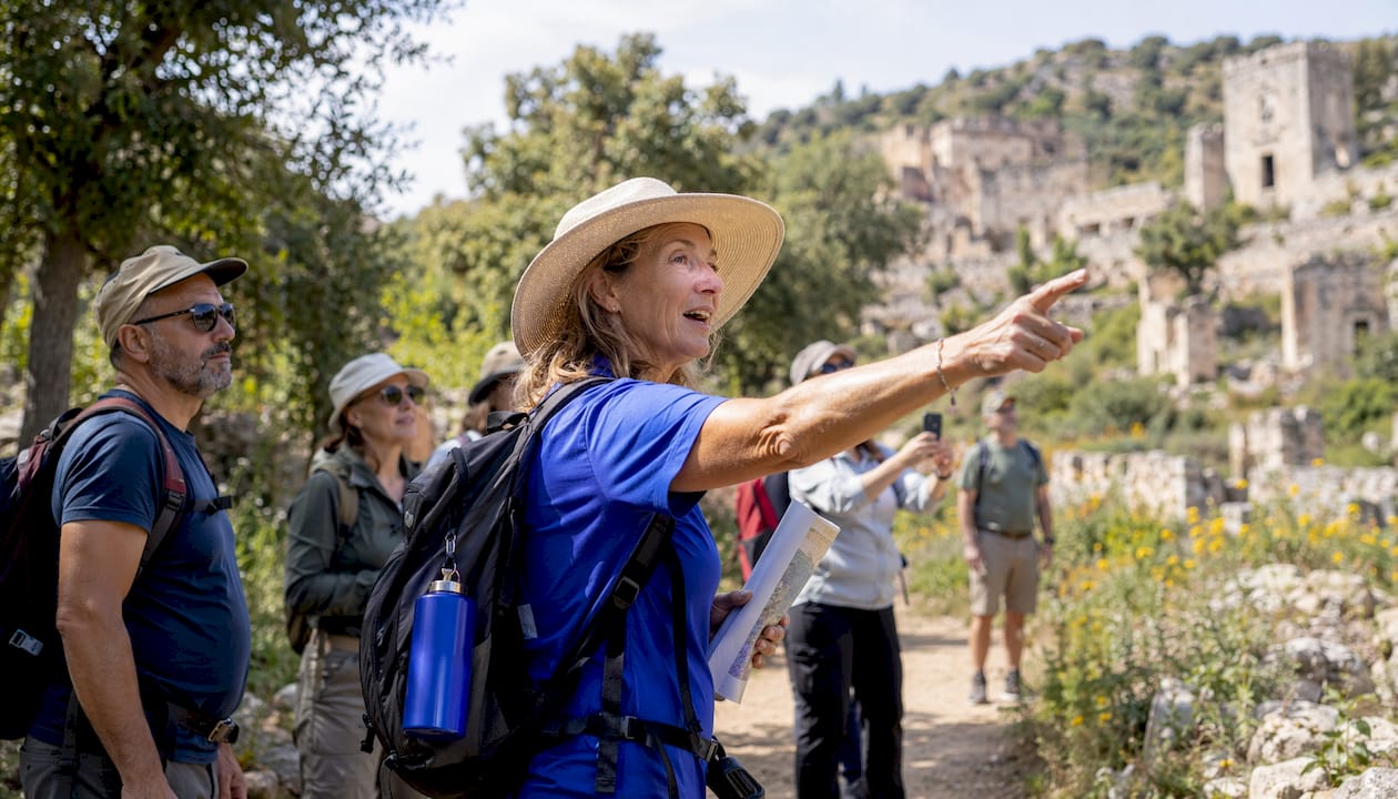 Tour guide explaining historic ruins to travelers