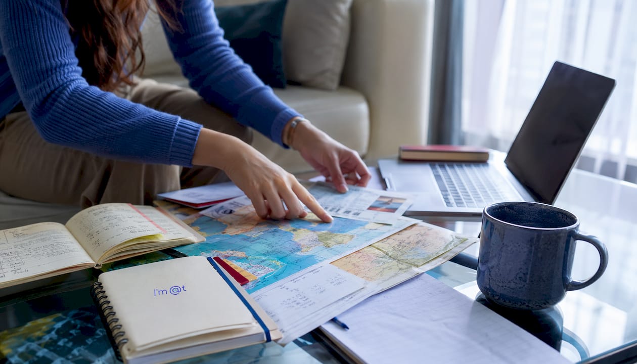 Close-up of hands arranging travel bundle components