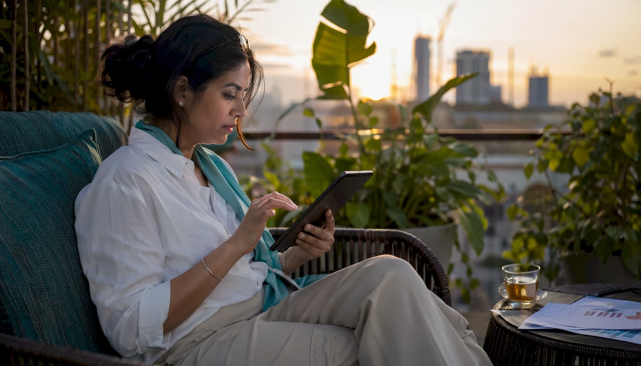 Woman using tablet for crypto subscription payments