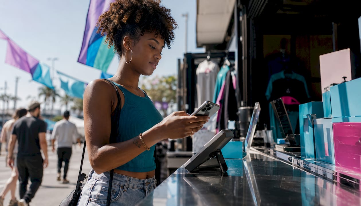 Woman buying gift cards using Apple Pay on iPhone