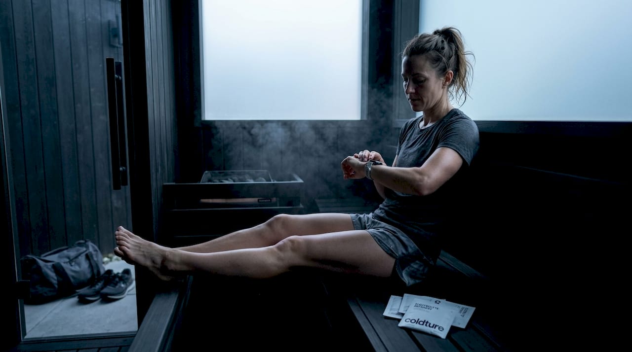 Athlete in backyard sauna after training