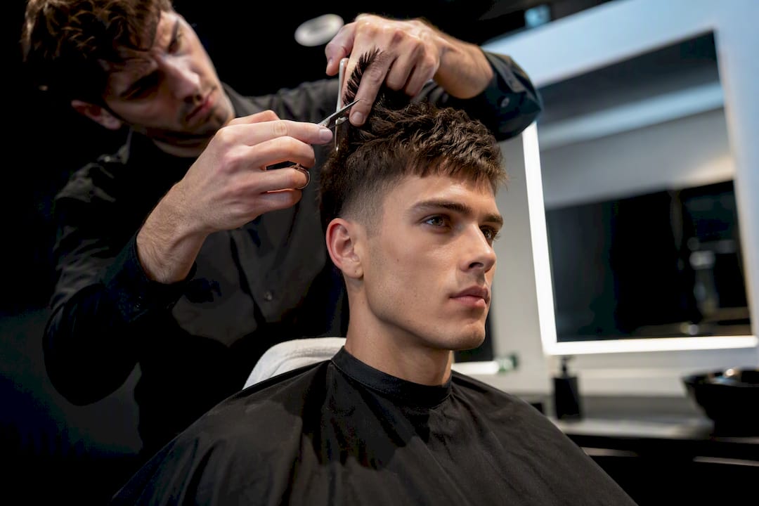 Friseur stylt strukturierten Herren-Crop