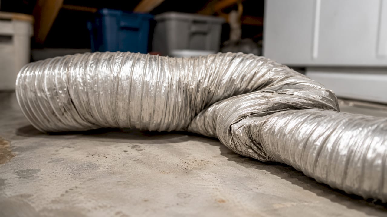 Crushed flexible dryer duct showing airflow restriction