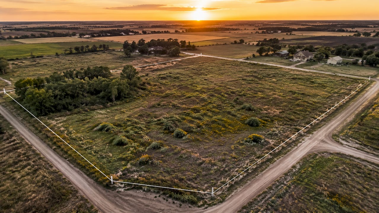 Aerial shot of raw vacant land with boundaries