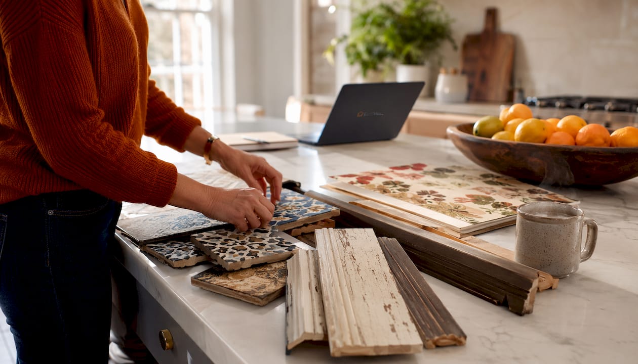 Close-up of hands arranging home feature samples on desk