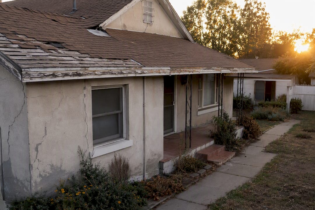 Exterior of house showing needed repairs and wear
