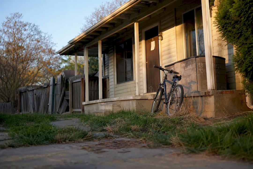 House exterior with tenant belongings and notice
