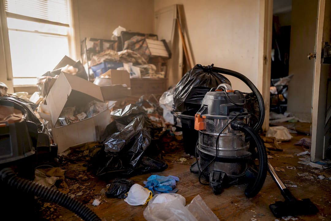 Professional cleanup equipment active in hoarder house