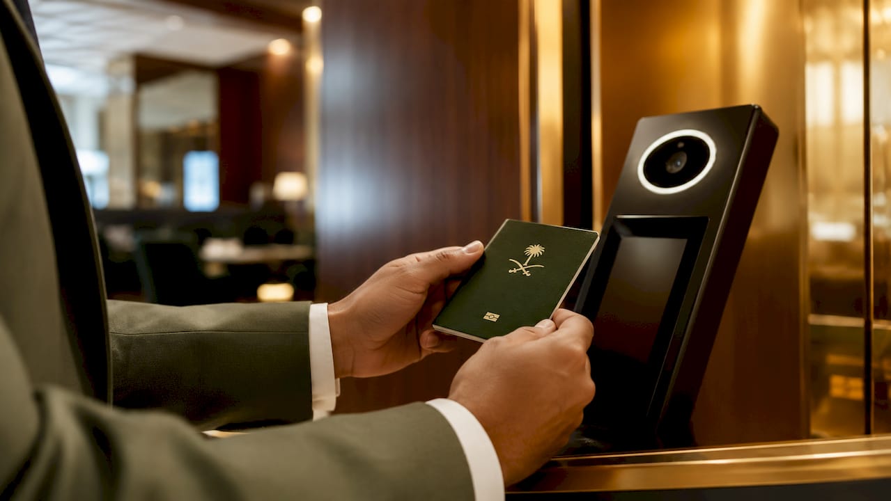 Traveler using biometric passport scanner at airport