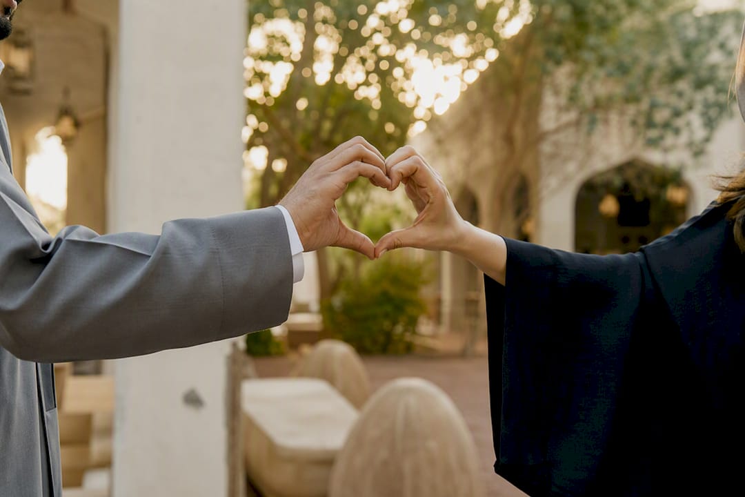 Hands performing heart-touch greeting gesture