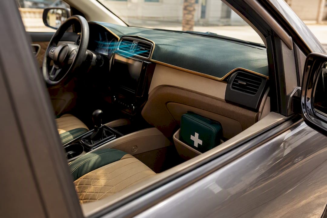 Vehicle interior with visible first-aid kit and air conditioning vents
