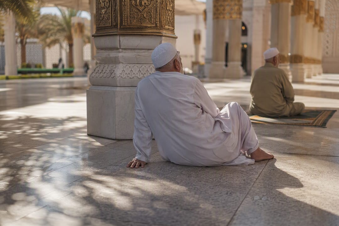 Marble courtyard and hands at Prophet's Mosque