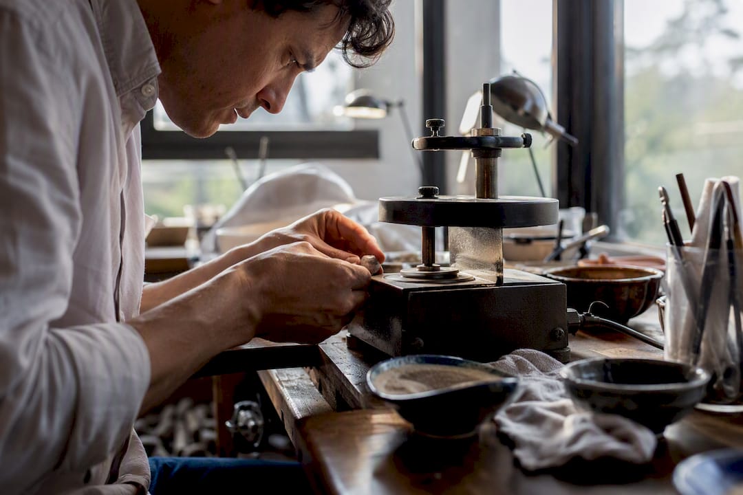 Gem cutter polishing gemstone facets by hand