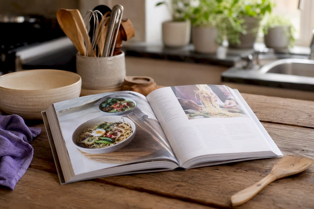 Cookbook with lay-flat binding open on kitchen counter