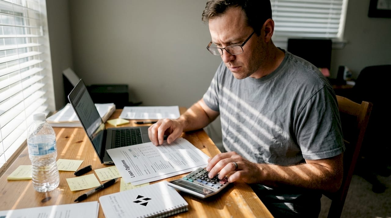 Man calculating home loan options in office