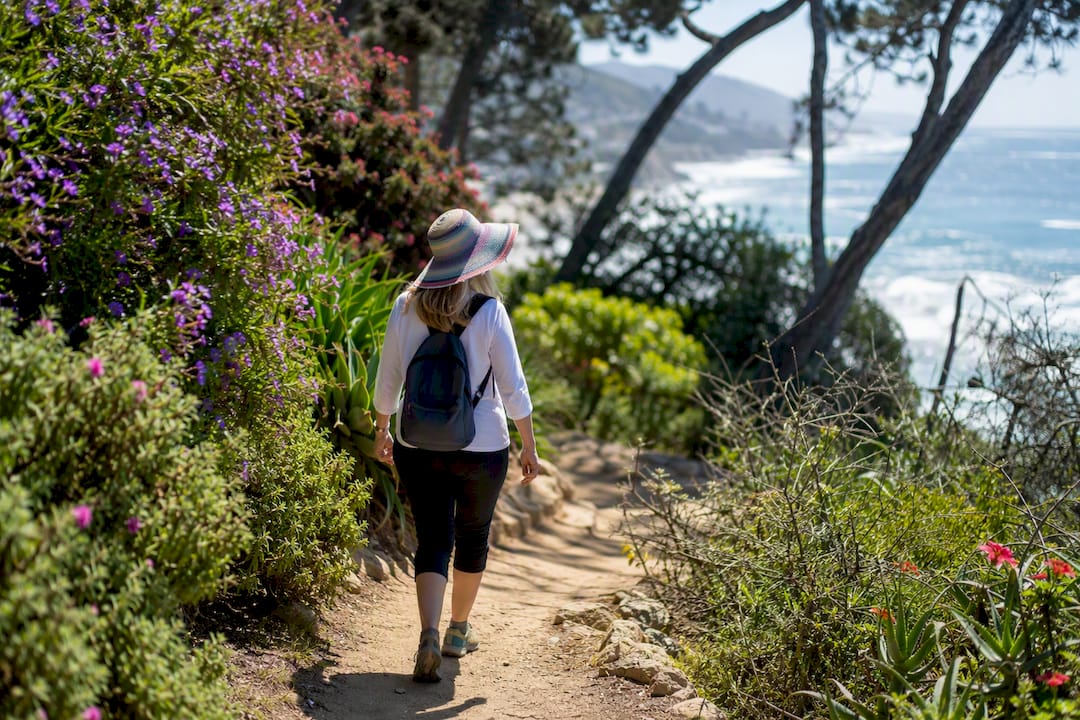 Resident hiking coastal trail near Laguna Beach home
