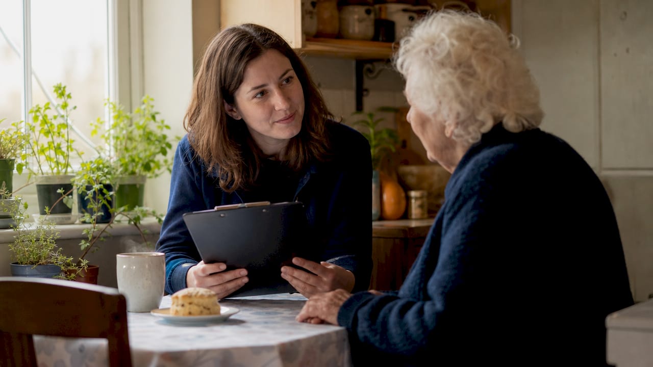 Practitioner conducting behaviour assessment in home
